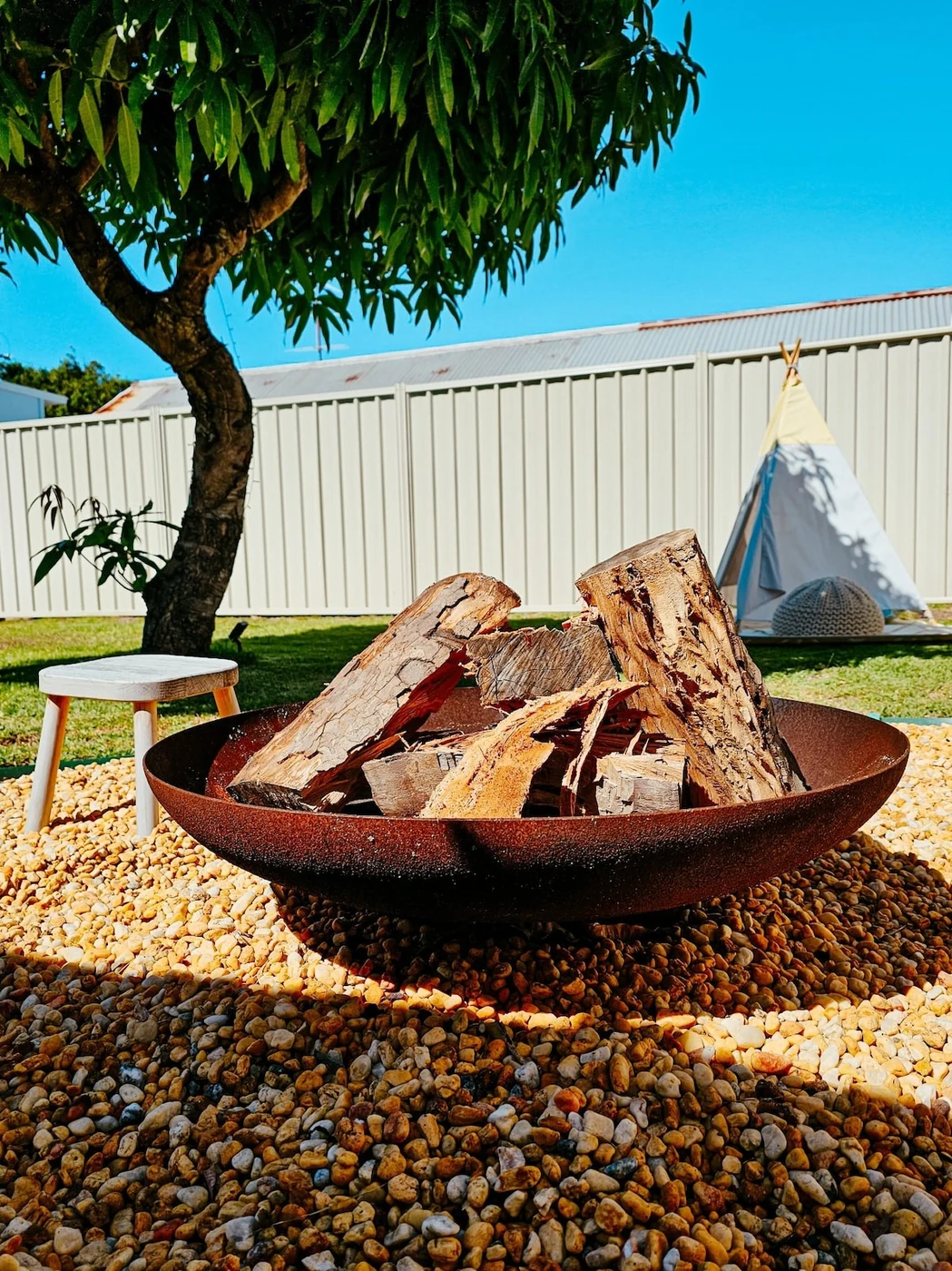 Firepit with kids tent in the backyard