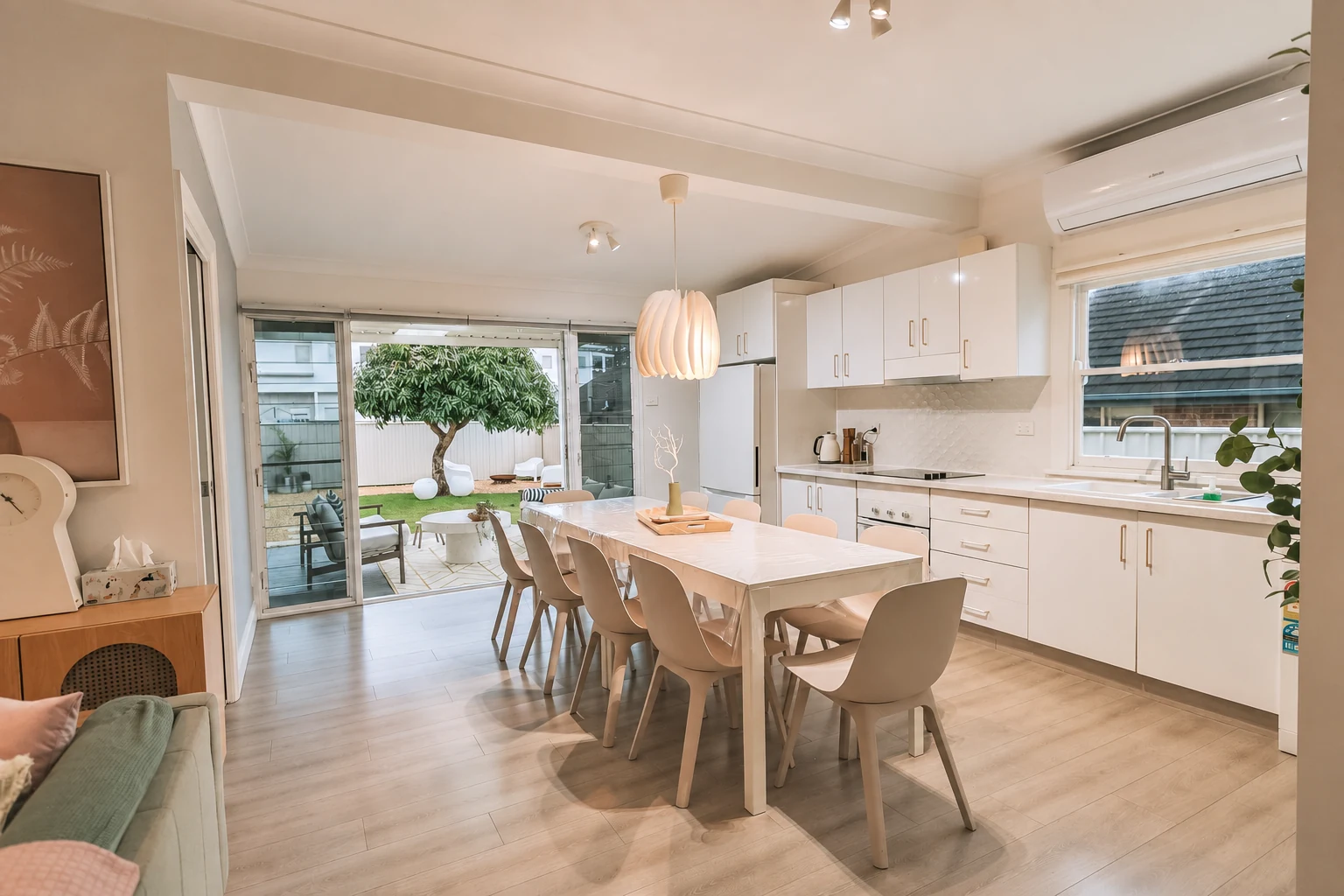 Open-plan kitchen and dining area with backyard view for shared meals